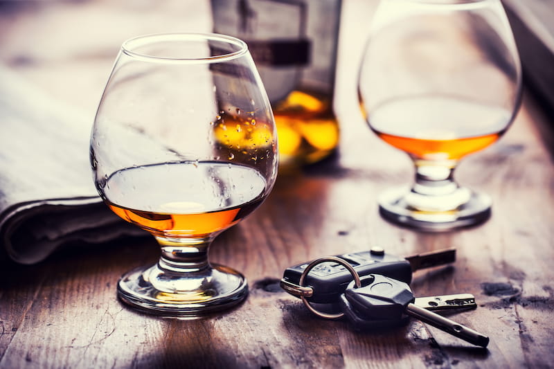 Two cups of cognac brandy or rum with car keys